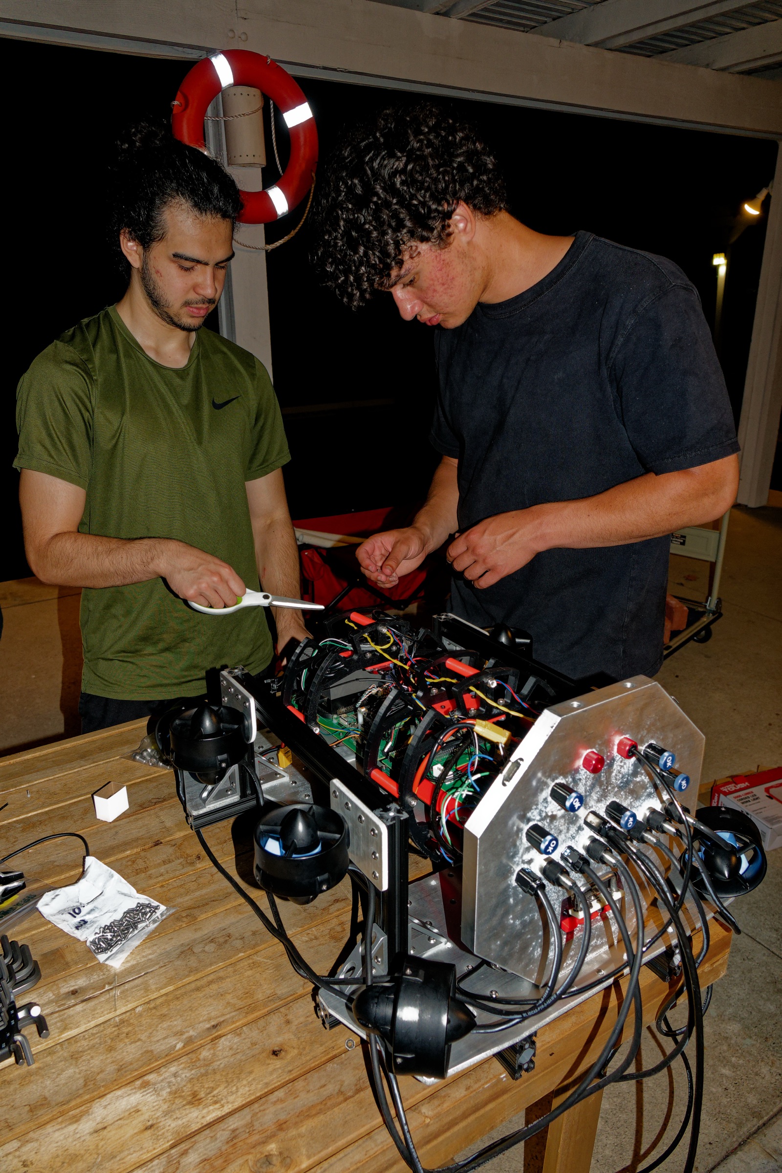 Team members rewiring and reassembling Barracuda onto a lighter frame during the overnight rebuild.