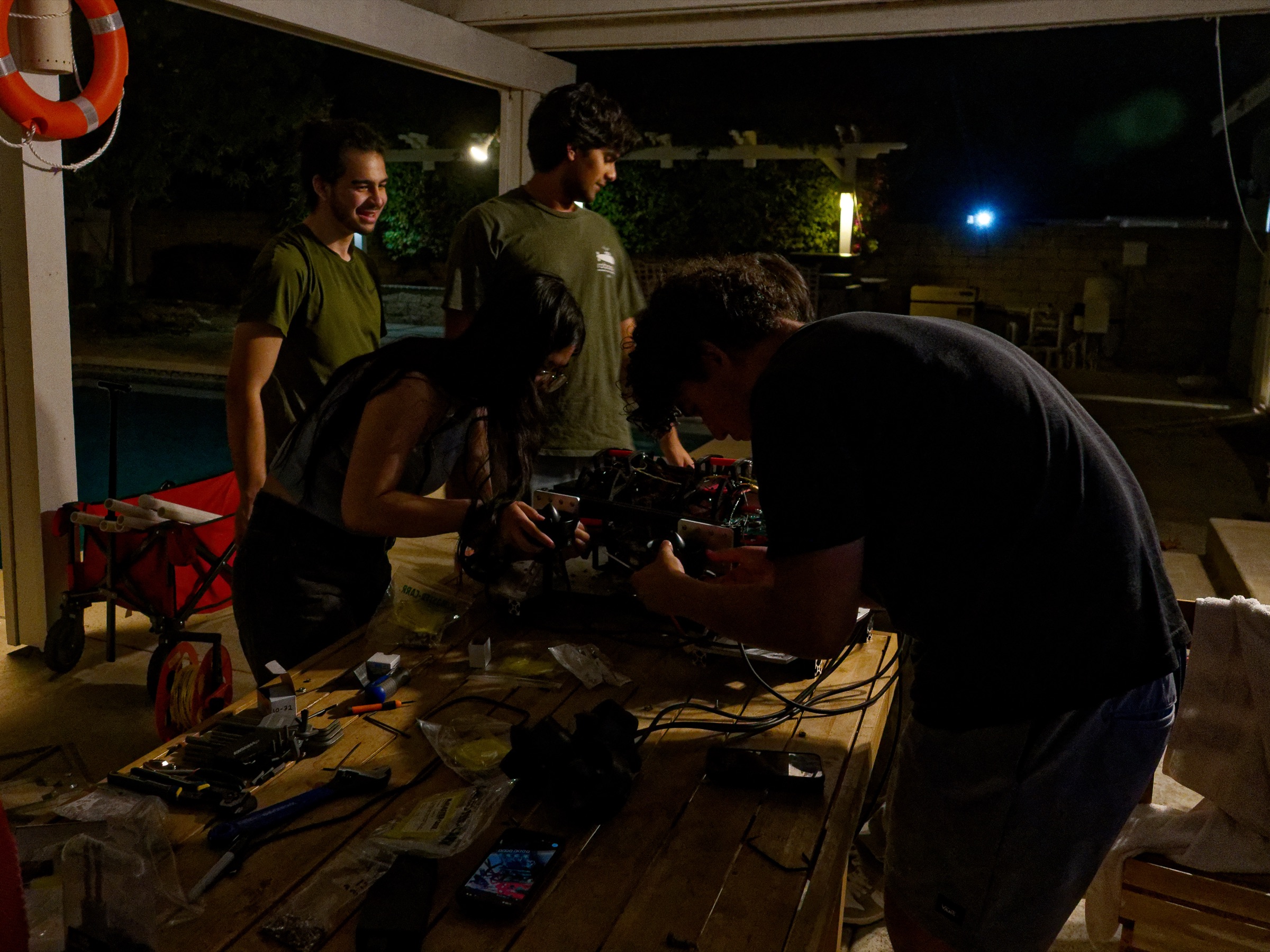 The team transferring components onto Barracuda's lighter frame during the overnight rebuild.